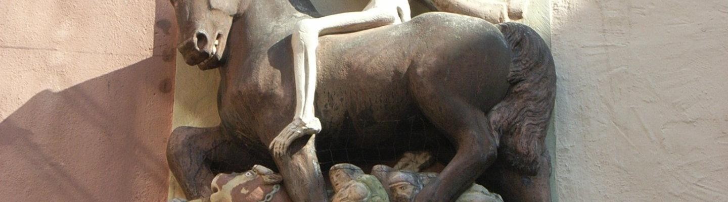 Sensenmann auf einem Pferd; darunter tote Soldaten und Zivilisten