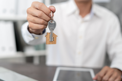 Das Foto zeigt die Schlüsselübergabe einer Immobilie.