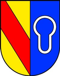 Wappen Schluttenbach: In gespaltenem Schild vorn in Gold ein roter Schrägbalken, hinten in Blau das silberne Ortszeichen in Form eines Kettengliedes.